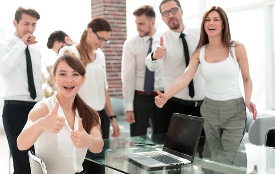 smiling business team showing thumbs up.success concept