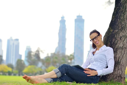 Beautiful young student  woman study with tablet in park