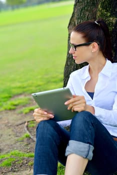 Beautiful young student  woman study with tablet in park