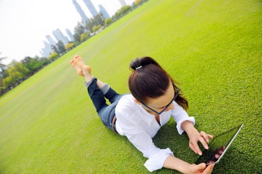 Beautiful young student  woman study with tablet in park