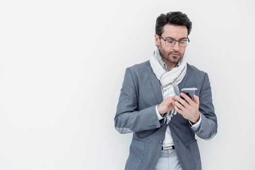 businessman with scarf on neck typing SMS on smartphone.photo with copy space