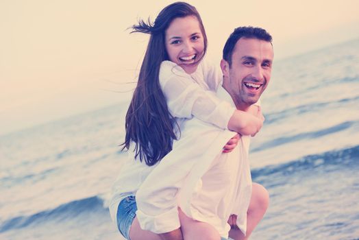 happy young romantic couple in love have fun on beautiful beach at beautiful summer day