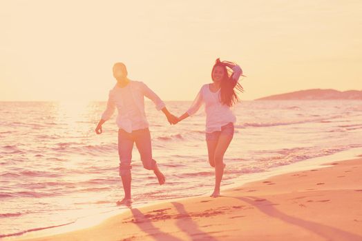 happy young romantic couple in love have fun on beautiful beach at beautiful summer day