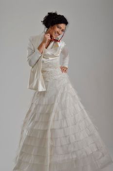 Portrait of a beautiful woman dressed as a bride isolated on white background in studio