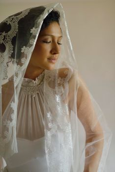 Portrait of a beautiful woman dressed as a bride isolated on white background in studio