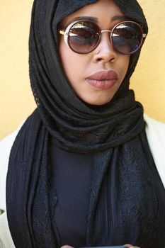 african  business woman using smart phone wearing traditional islamic clothes