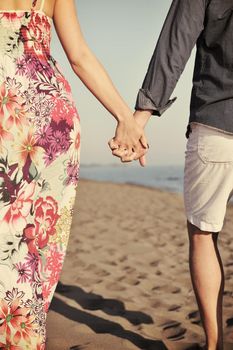 couple on beach with travel bag representing freedom and funy honeymoon concept