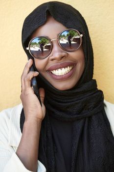 african  business woman using smart phone wearing traditional islamic clothes