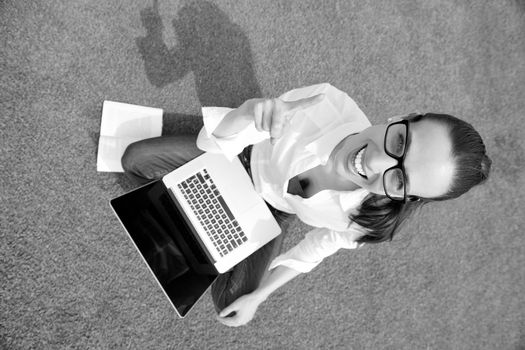 happy young student woman with laptop in city park study