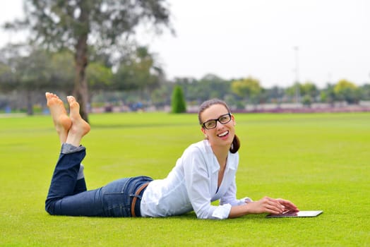 Beautiful young student  woman study with tablet in park