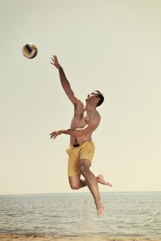 male beach volleyball game player jump on hot sand