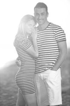 happy young couple have romantic time on beach at sunset