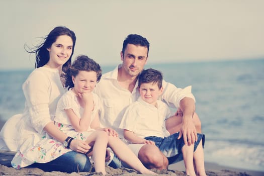 happy young family have fun and live healthy lifestyle on beach