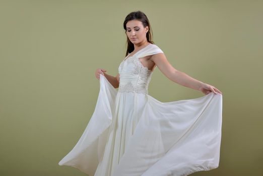 Portrait of a beautiful woman dressed as a bride isolated on white background in studio