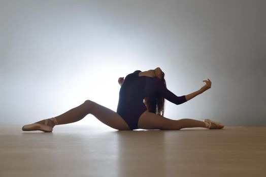 modern style ballet dancer posing and jumping on training