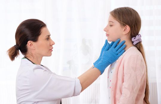 Qualified pediatrician in gloves checking teens lymph nodes
