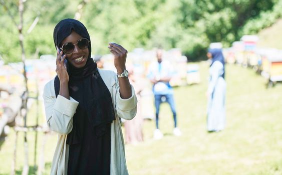 african  business woman using smart phone wearing traditional islamic clothes