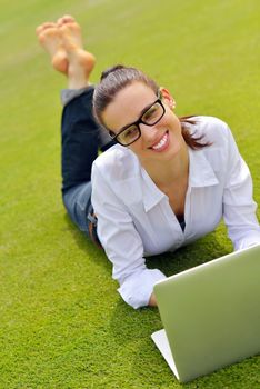 happy young student woman with laptop in city park study