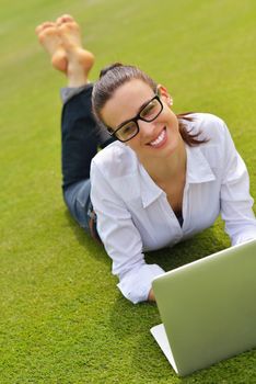 happy young student woman with laptop in city park study