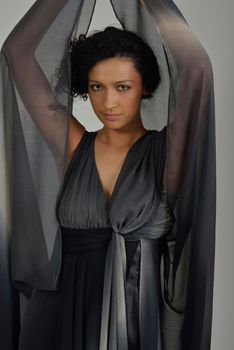 elegant woman in  fashionable  stylish dress posing in the studio