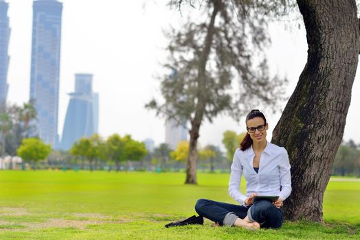 Beautiful young student  woman study with tablet in park