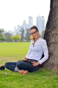 Beautiful young student  woman study with tablet in park