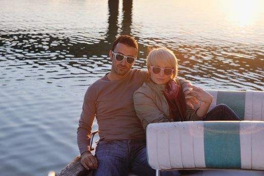 happy young couple in love  have romantic time at summer sunset   at ship boat while  representing urban and countryside fashin lifestyle