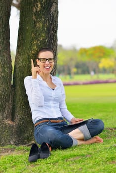 Beautiful young student  woman study with tablet in park