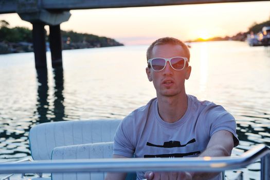 happy young man have fun at boat at sunset on summer season