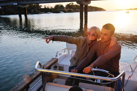 happy young couple in love  have romantic time at summer sunset   at ship boat while  representing urban and countryside fashin lifestyle