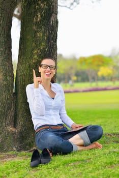 Beautiful young student  woman study with tablet in park