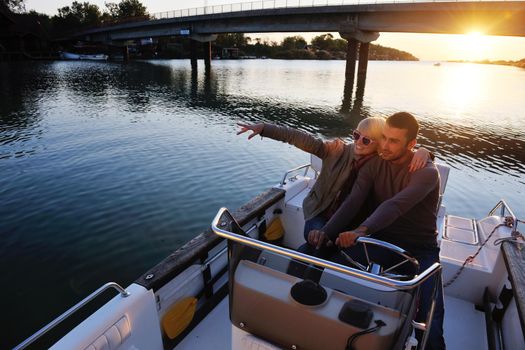 happy young couple in love  have romantic time at summer sunset   at ship boat while  representing urban and countryside fashin lifestyle