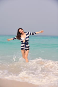 Happy Beautiful Woman Enjoying Summer Vacation on beach