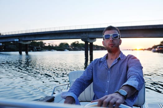 happy young man have fun at boat at sunset on summer season