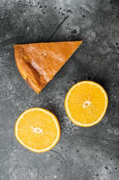 Orange and mandarin cake with polenta set, on black dark stone table background, top view flat lay