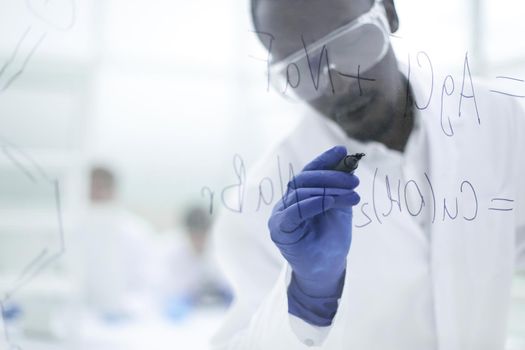 scientist writing chemical formula on a glass Board.photo with copy space