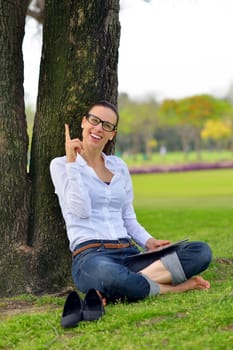 Beautiful young student  woman study with tablet in park