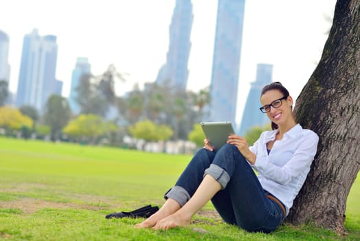 Beautiful young student  woman study with tablet in park