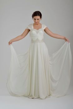 Portrait of a beautiful woman dressed as a bride isolated on white background in studio