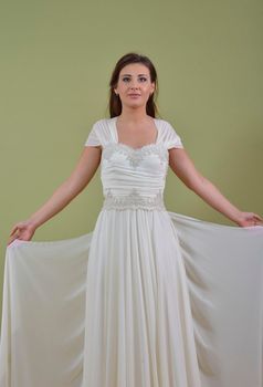 Portrait of a beautiful woman dressed as a bride isolated on white background in studio