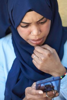 african  business woman using smart phone wearing traditional islamic clothes