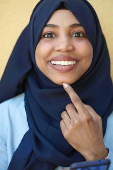 african  business woman using smart phone wearing traditional islamic clothes