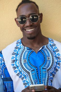 Native Sudan black african man using smart phone and wearing traditional clothes