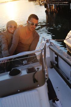 happy young couple in love  have romantic time at summer sunset   at ship boat while  representing urban and countryside fashin lifestyle