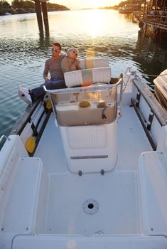 happy young couple in love  have romantic time at summer sunset   at ship boat while  representing urban and countryside fashin lifestyle