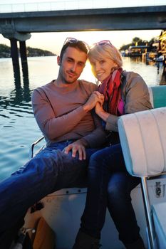 happy young couple in love  have romantic time at summer sunset   at ship boat while  representing urban and countryside fashin lifestyle