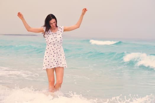 Happy Beautiful Woman Enjoying Summer Vacation on beach