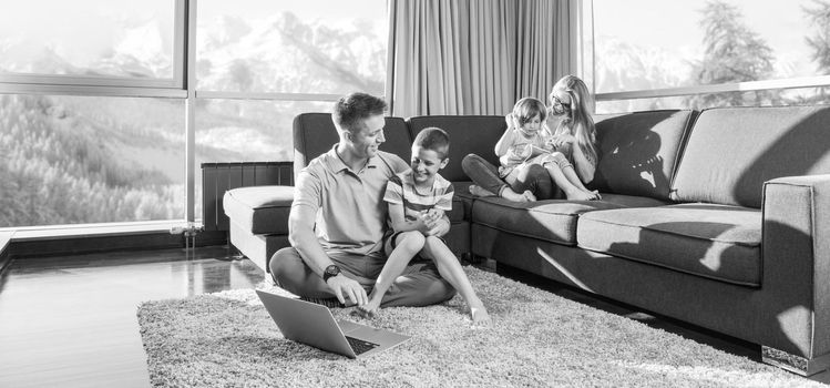 Happy family. Father, mother and children playing a video game Father and son playing video games together on the floor