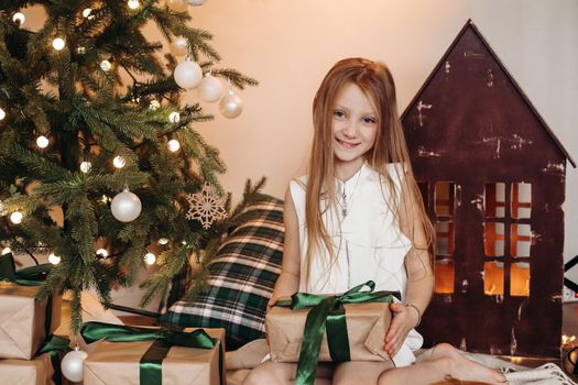 Picture of cute little girl smiles with a christmas gift