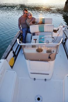 happy young couple in love  have romantic time at summer sunset   at ship boat while  representing urban and countryside fashin lifestyle